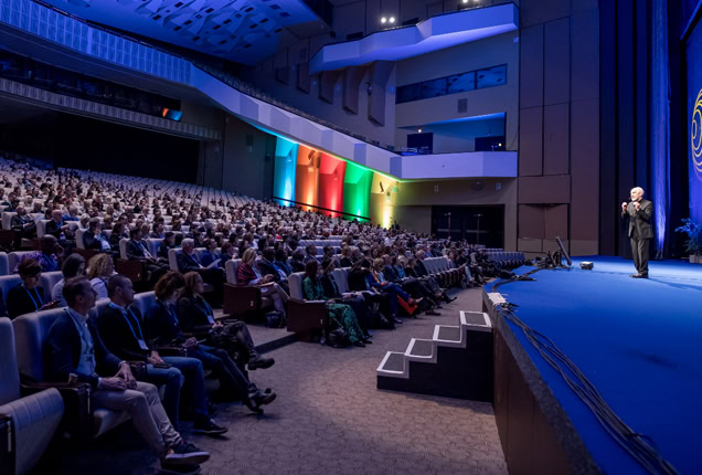 A speaker on stage at WOC